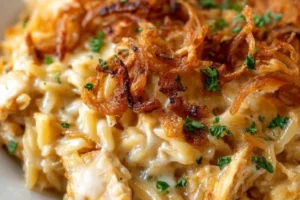 Savory French Onion Chicken Orzo Casserole topped with melted cheese.