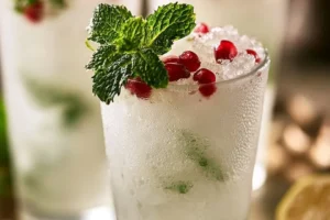 White Christmas Mojitos served in a festive glass with holiday decorations