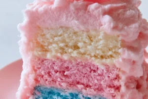 Delicious homemade cotton candy cake topped with colorful frosting and sprinkles