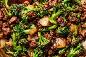 Caramelized ground beef with stir-fried baby broccoli served in a bowl.