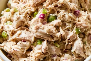 Creamy herb-infused roasted chicken salad with fresh vegetables and herbs