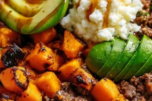 Hot honey glazed ground beef bowl with fresh vegetables and rice.