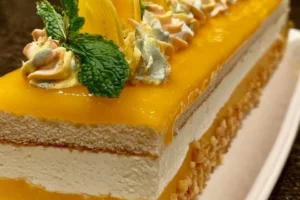Mango Coconut Cream Cake with tropical glaze and mango insert