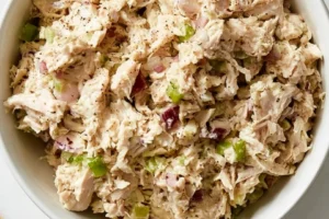 Delicious rotisserie-style chicken salad in a bowl with fresh vegetables