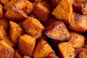 Crispy air fryer sweet potatoes served in a bowl garnished with herbs