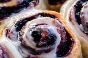 Freshly baked blueberry cinnamon rolls topped with icing